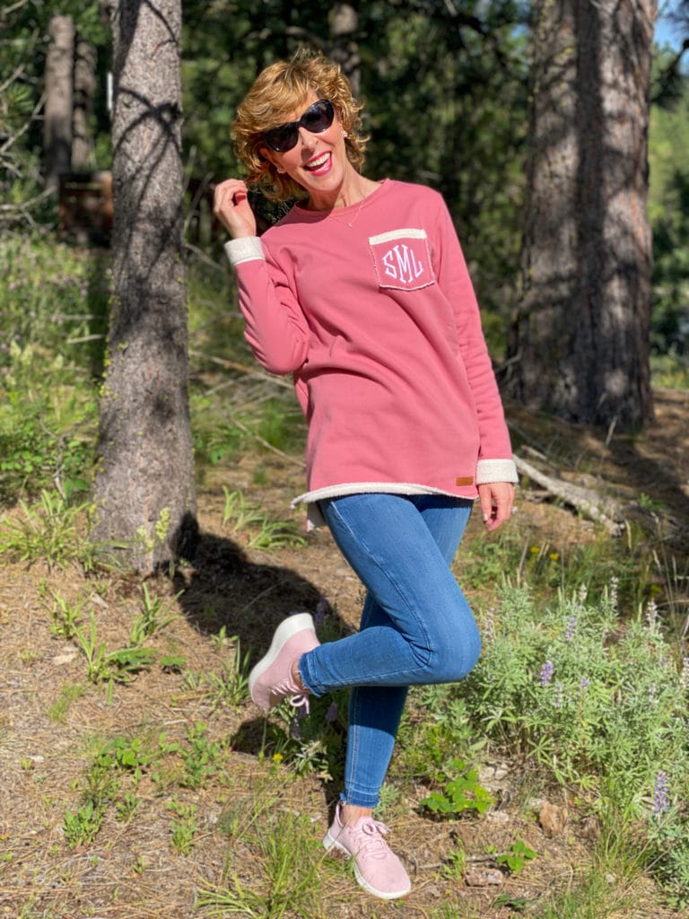 woman wearing marley lilly pink fleece sweater posing in the woods