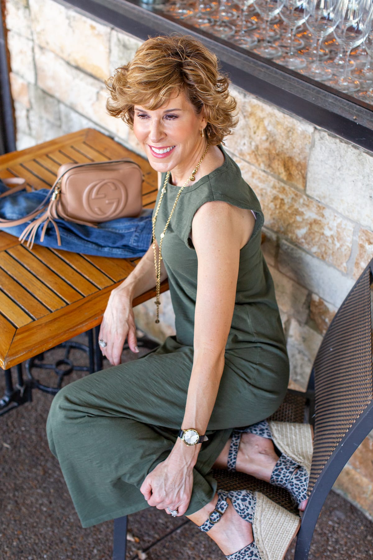 Woman in green dress sitting in a chair and looking off to one side