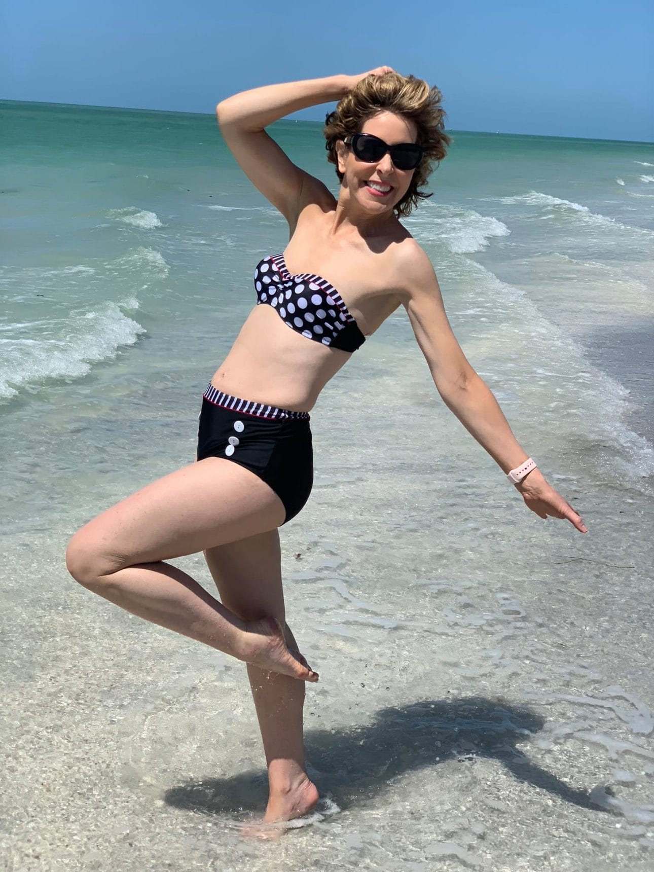 woman in two piece bathing suit on a beach