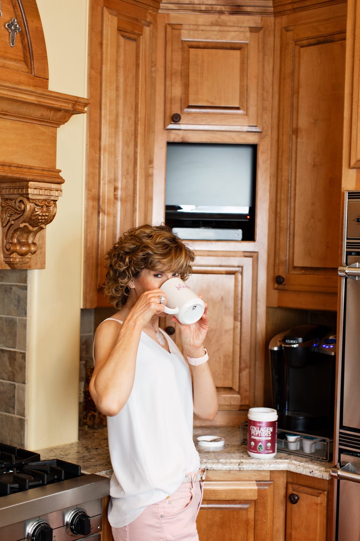woman drinking coffee with collagen powder in it