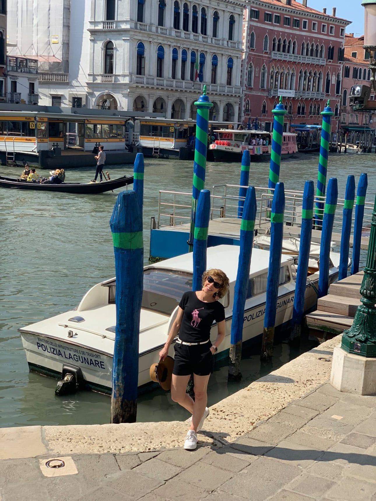woman posing by canals in venice greece