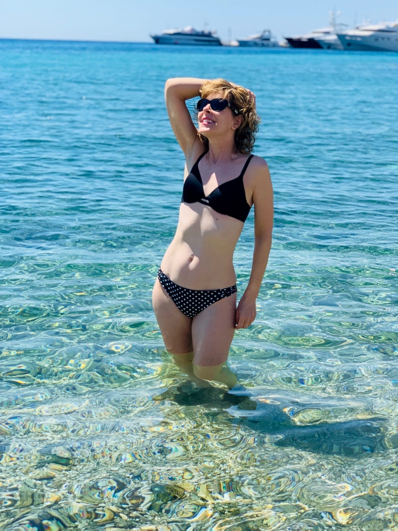 a girl in a bikini in mykonos greece