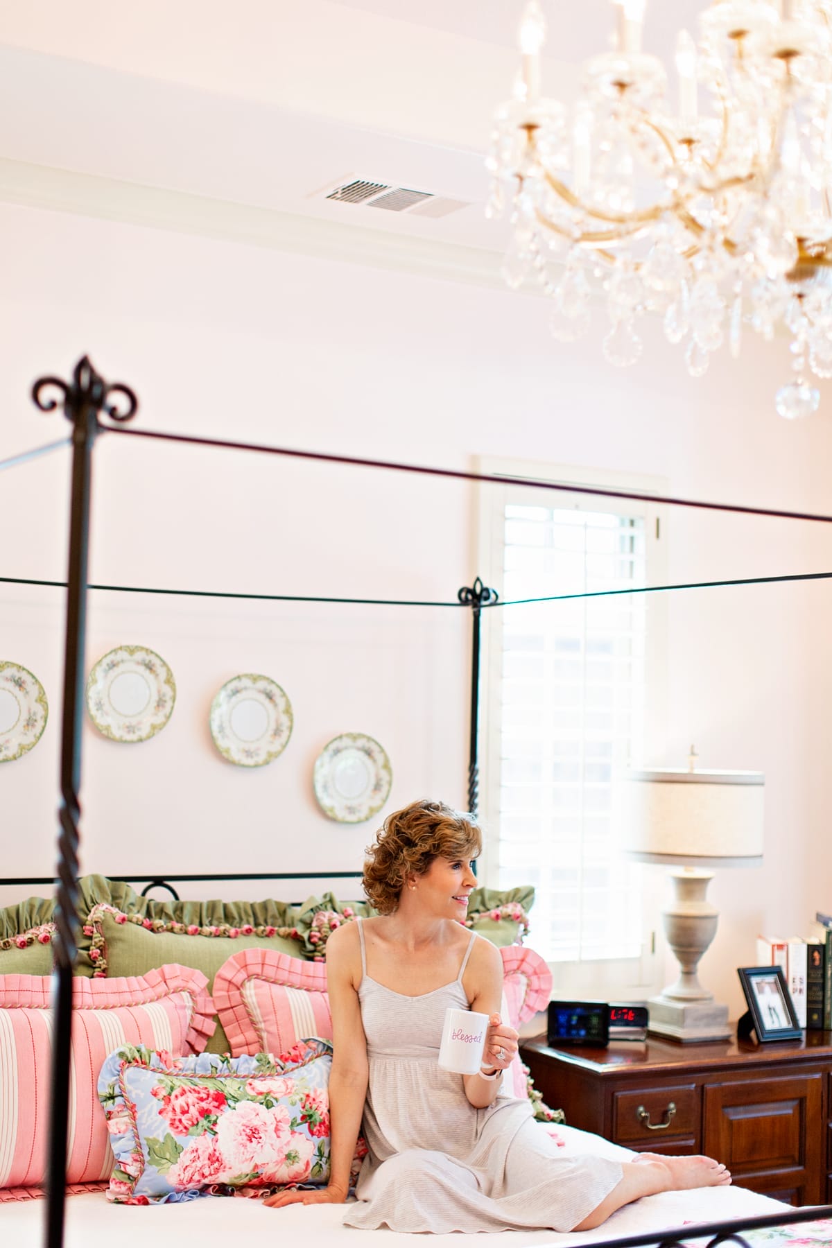 woman in nightgown on her bed thinking about why she is not sleeping well