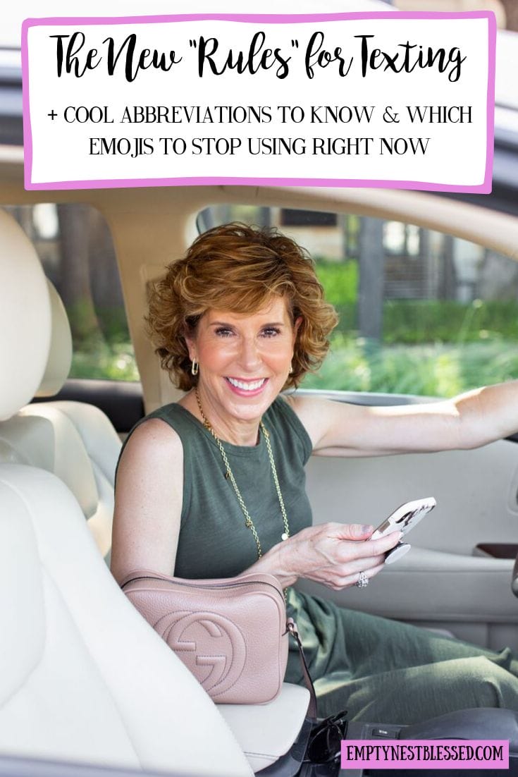 woman in green dress sitting in her car holding her phone looking at camera and reviewing the new rules for texting
