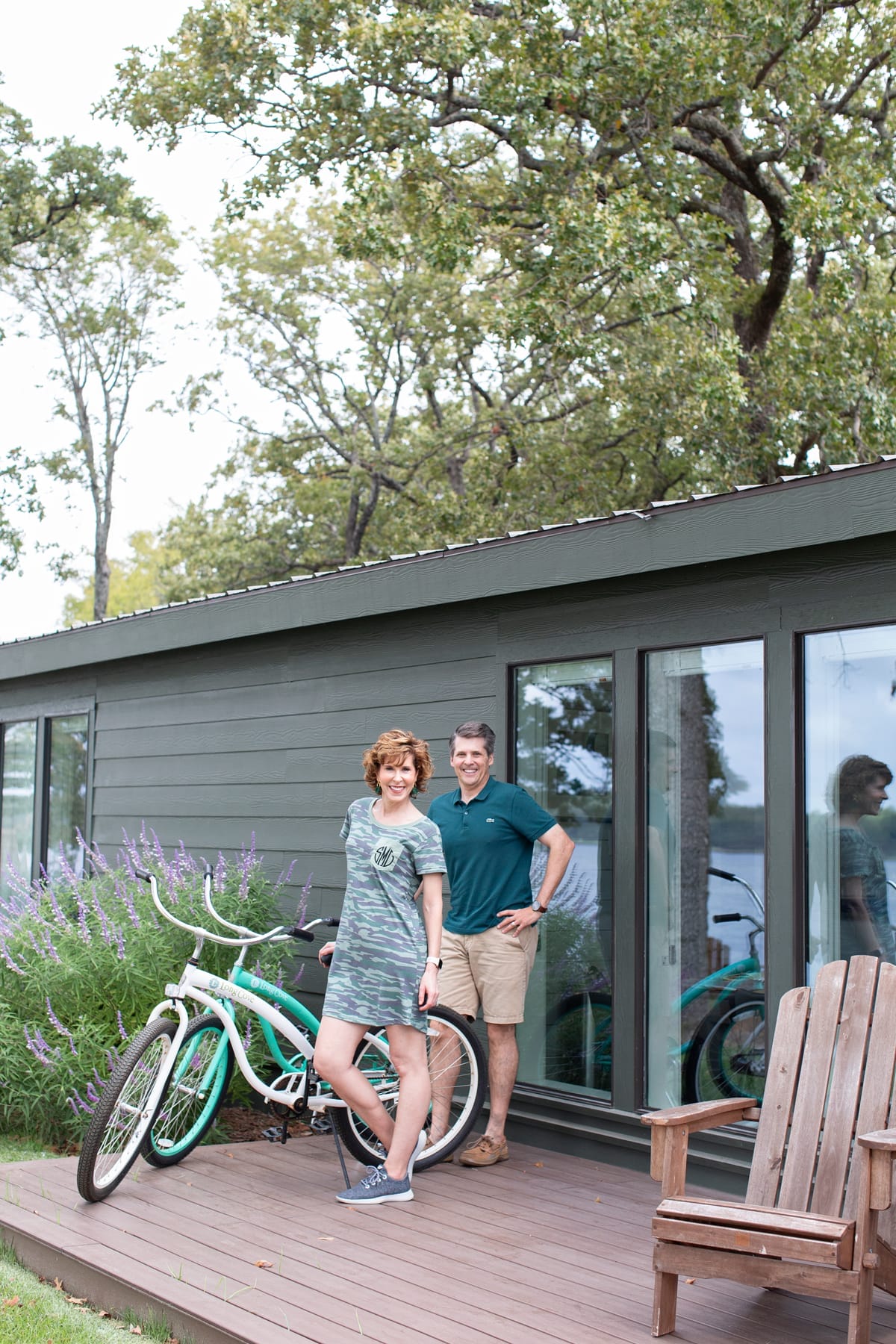 man and woman standing on a porch next to two bikes