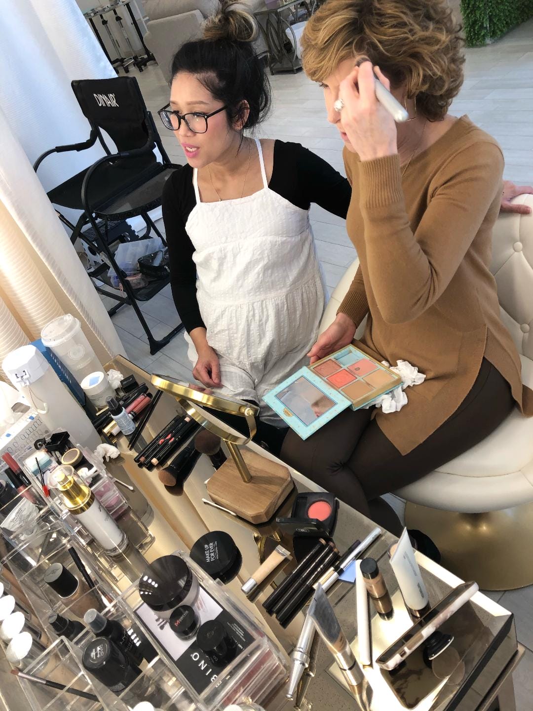 woman applying makeup during a makeup lesson