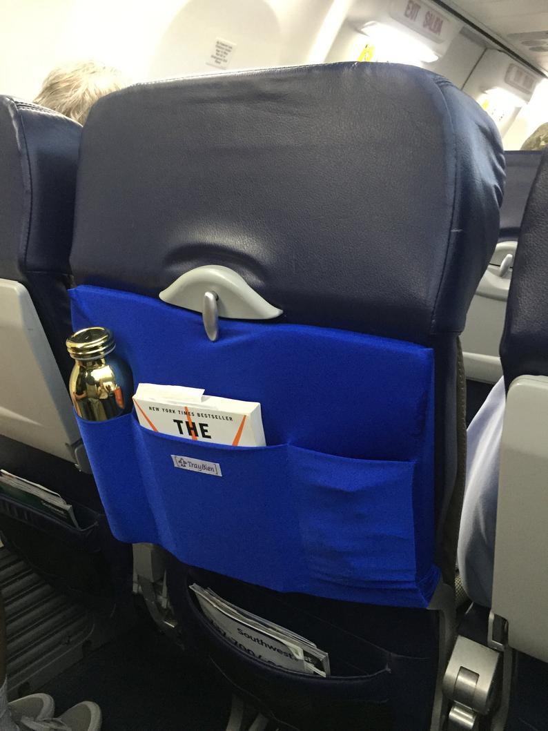 fly caddy attaches to back of airplane tray table