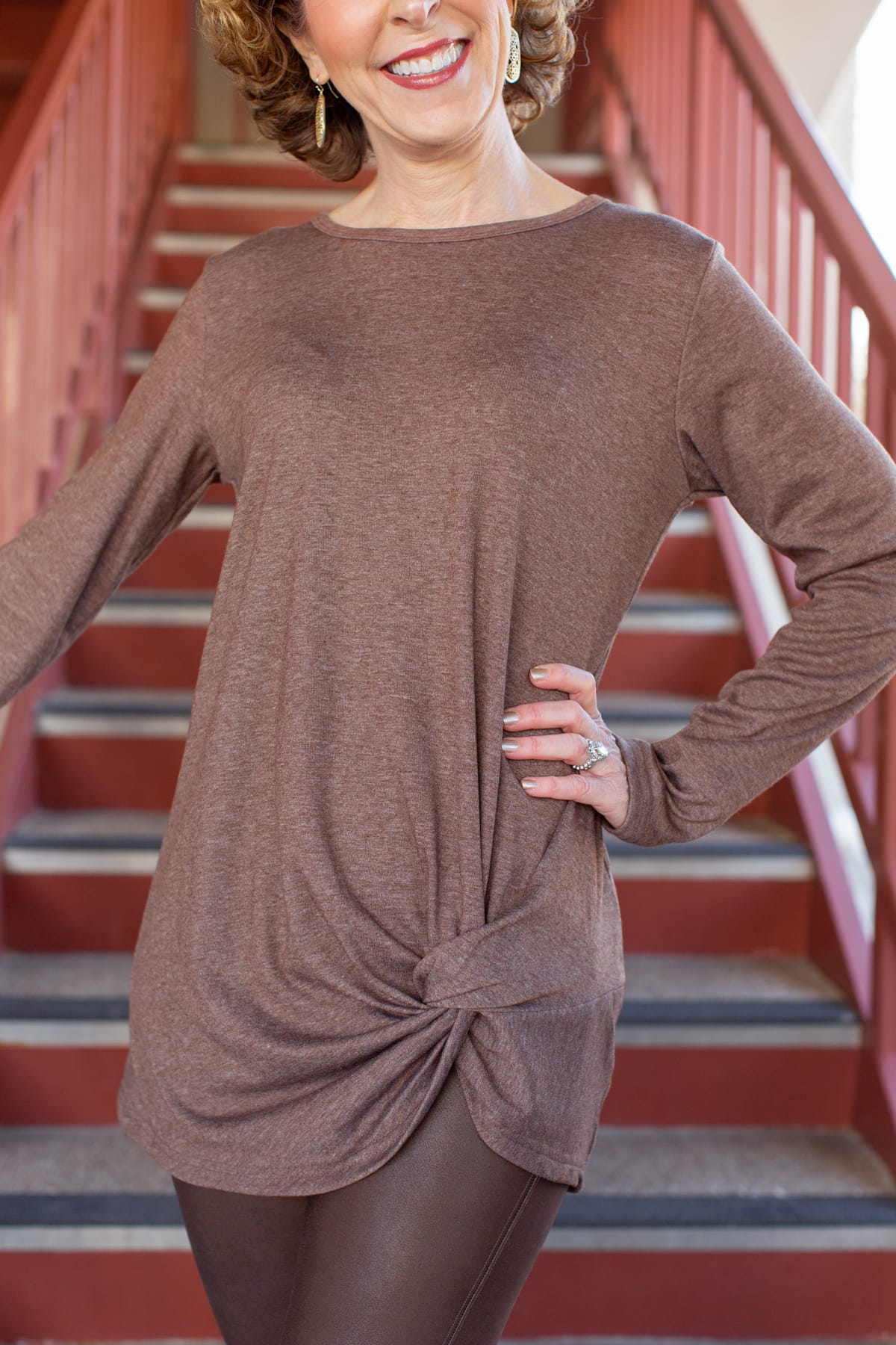 woman standing on stairs wearing amazon knotted front tunic tee