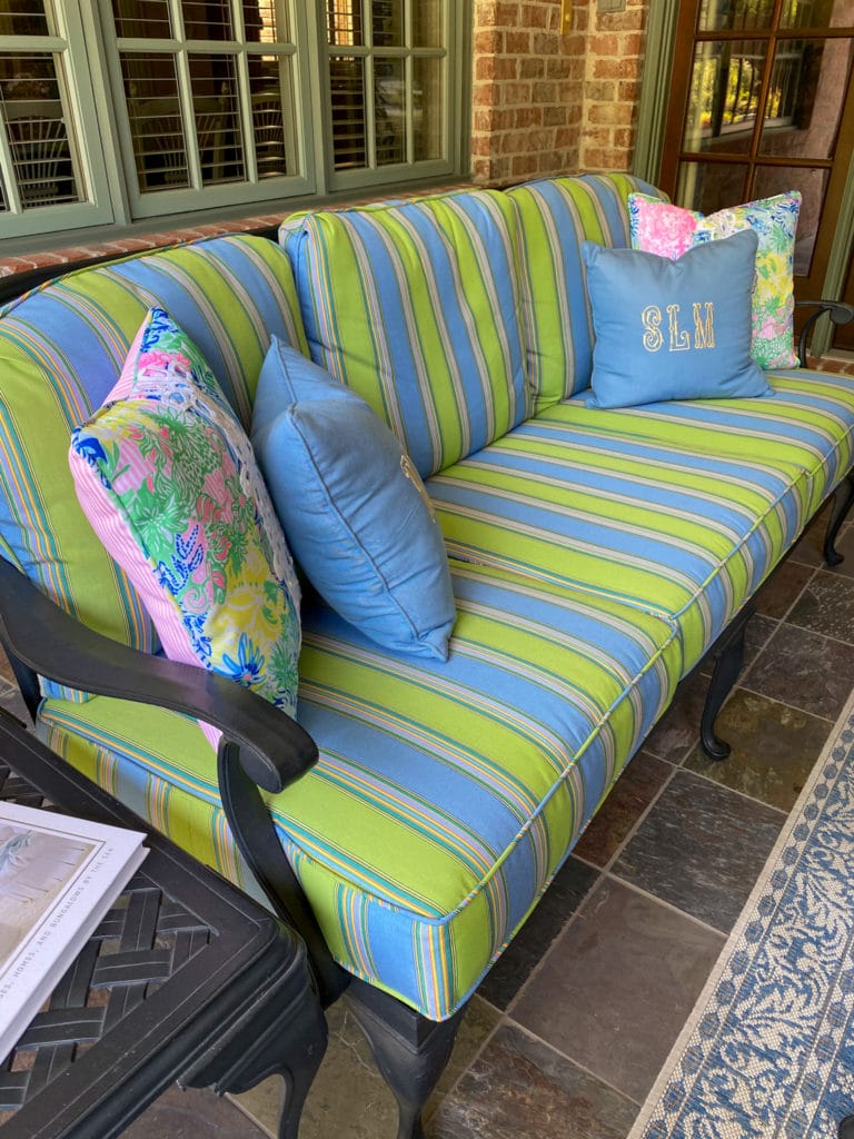 outdoor sofa with blue and green striped fabric cushions