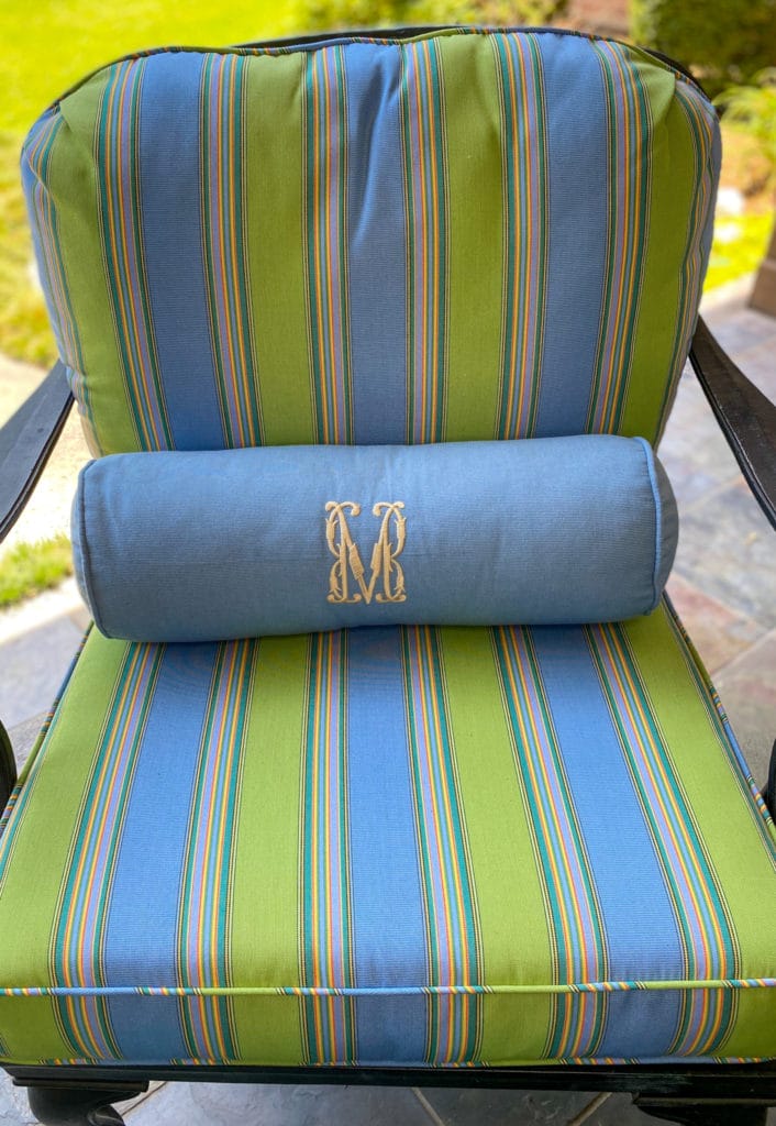 outdoor chair with blue and green striped fabric cushions