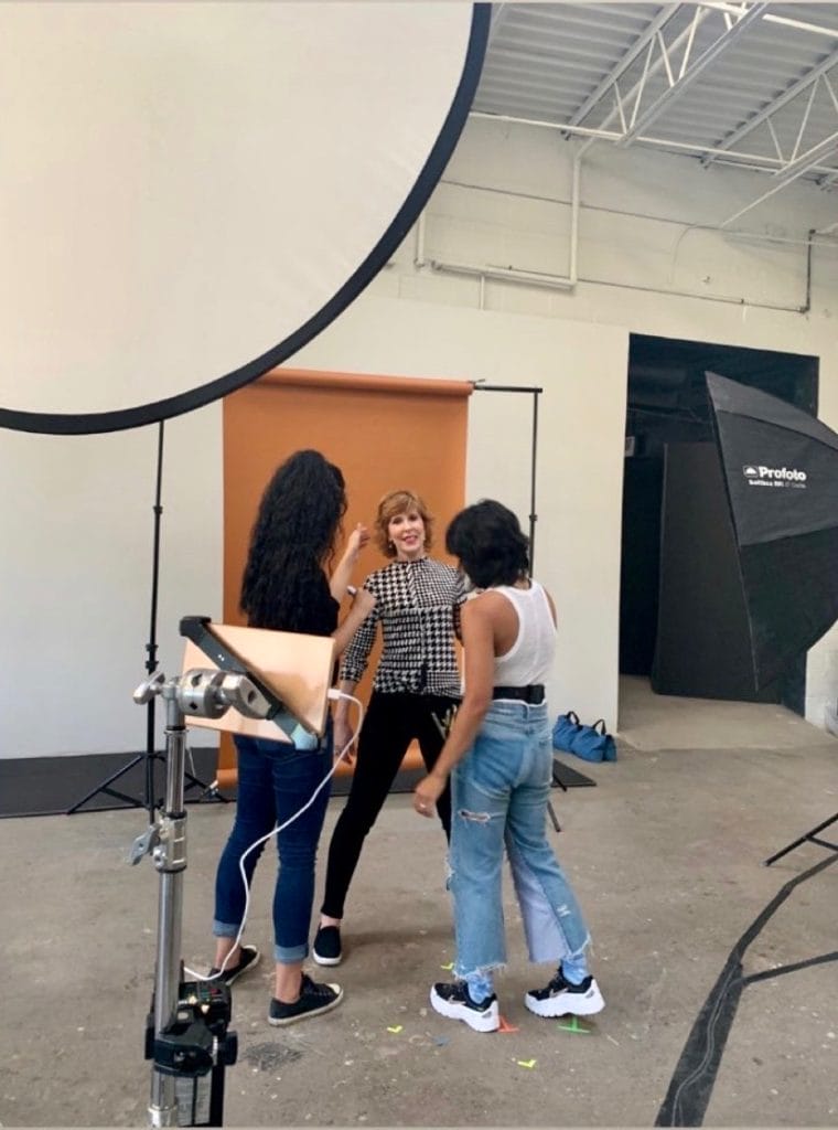 woman getting makeup and styling at photo shoot