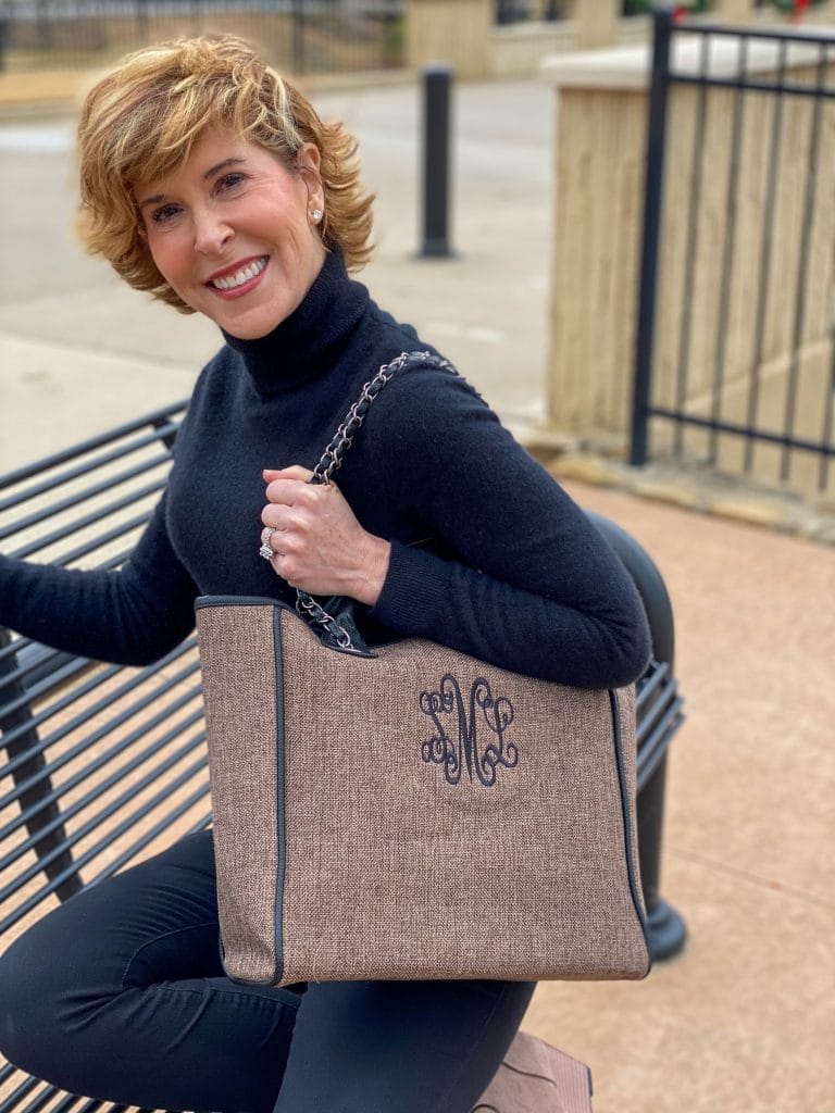 woman dressed in black turtleneck carrying Monogrammed Charlotte Handbag from marley lilly