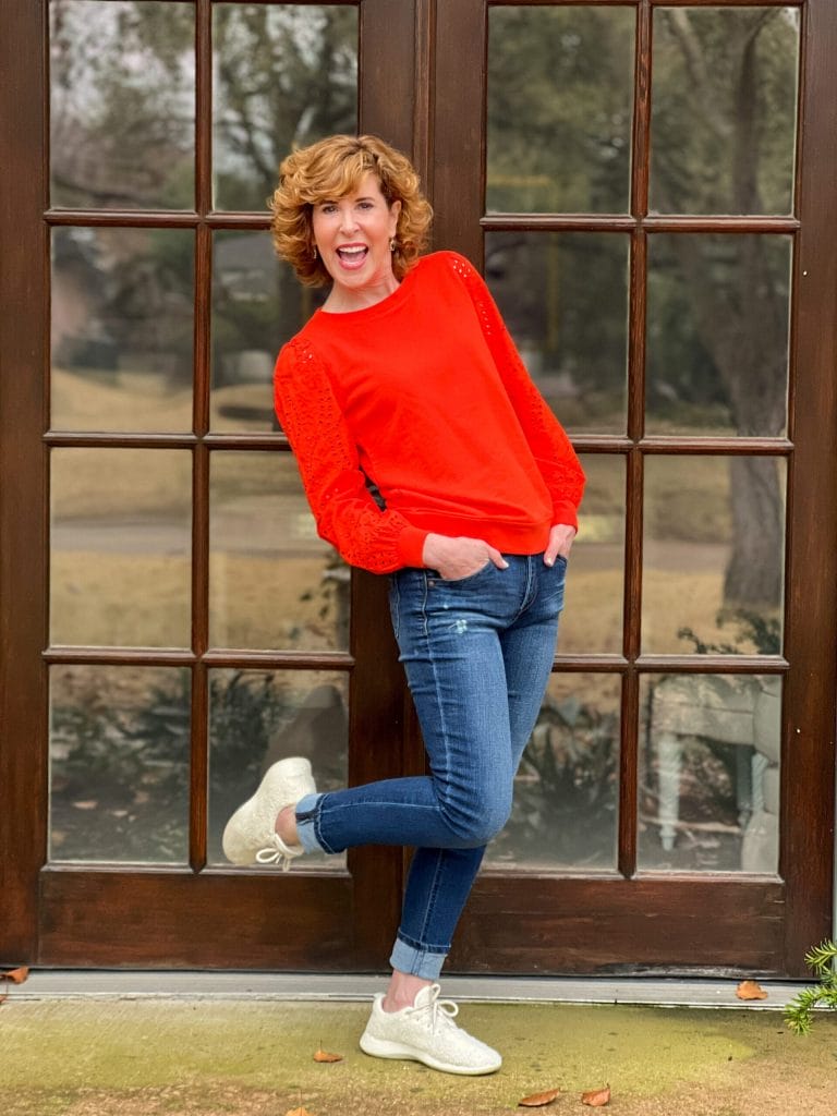 woman wearing talbots Eyelet Sleeve Crewneck Sweatshirt and jeans standing on porch