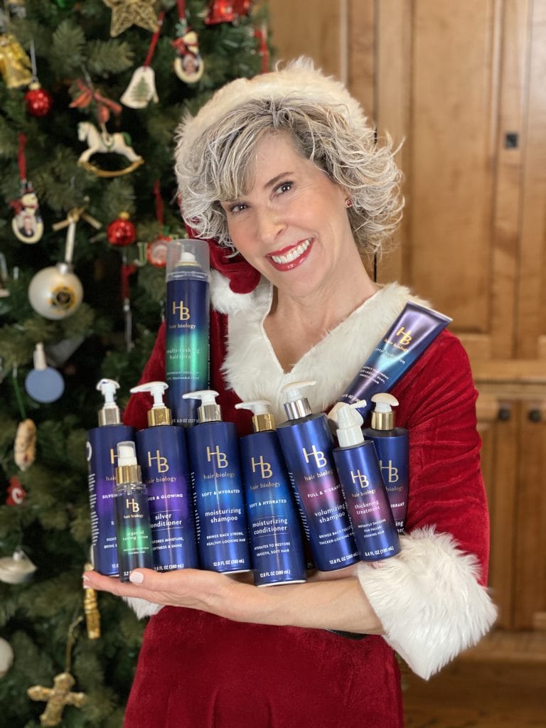 mrs claus holding the entire hair biology line