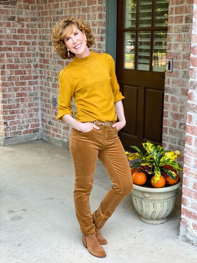 woman wearing amazon sweater and jcrew corduroy jeans with brown suede booties