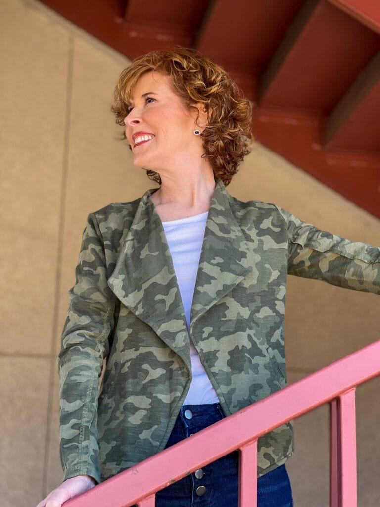 woman over 50 transitioning her wardrobe to spring with a camo drape front knit blazer