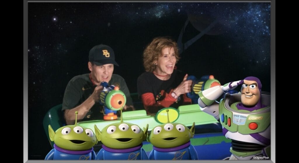 couple on the buzz lightyear ride during a multi-generational disney trip