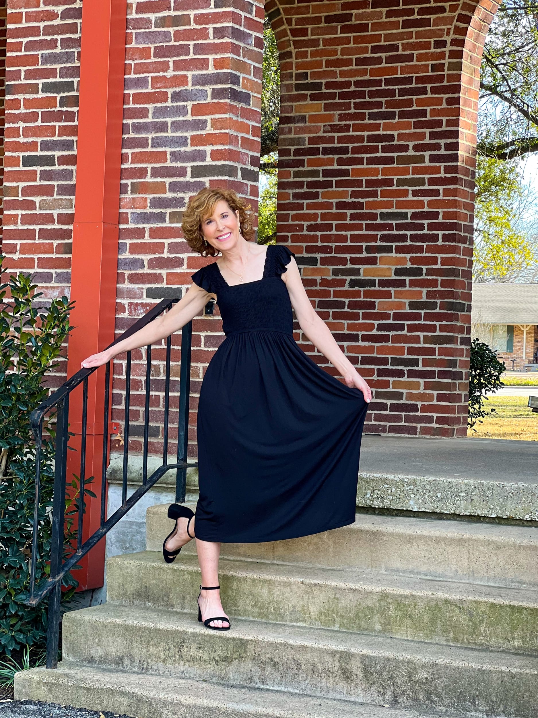 woman over 50 posing outside on a staircase wearing Moonlight Dress from NORDSTROM