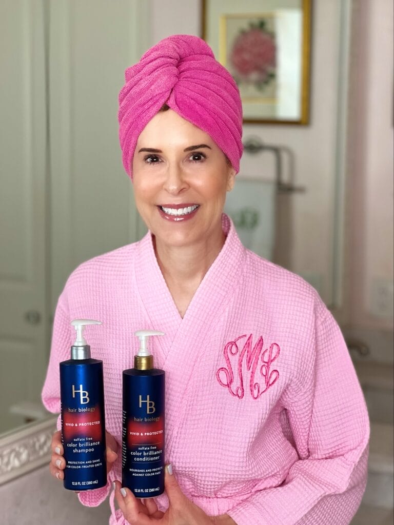 woman over 50 showing hair biology vivid and protected shampoo and conditioner 
