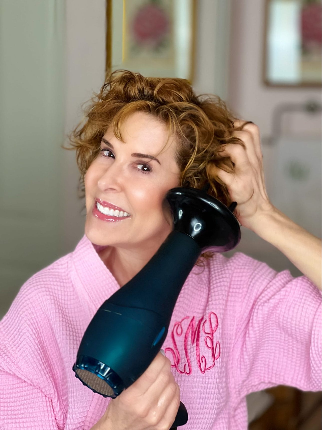 woman over 50 diffusing her curly hair