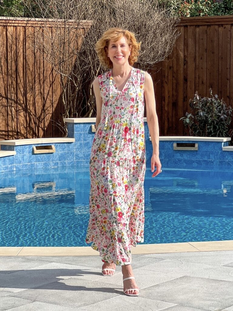 woman walking by a swimming pool wearing Caslon Floral Print Sleeveless Maxi Dress from Nordstrom