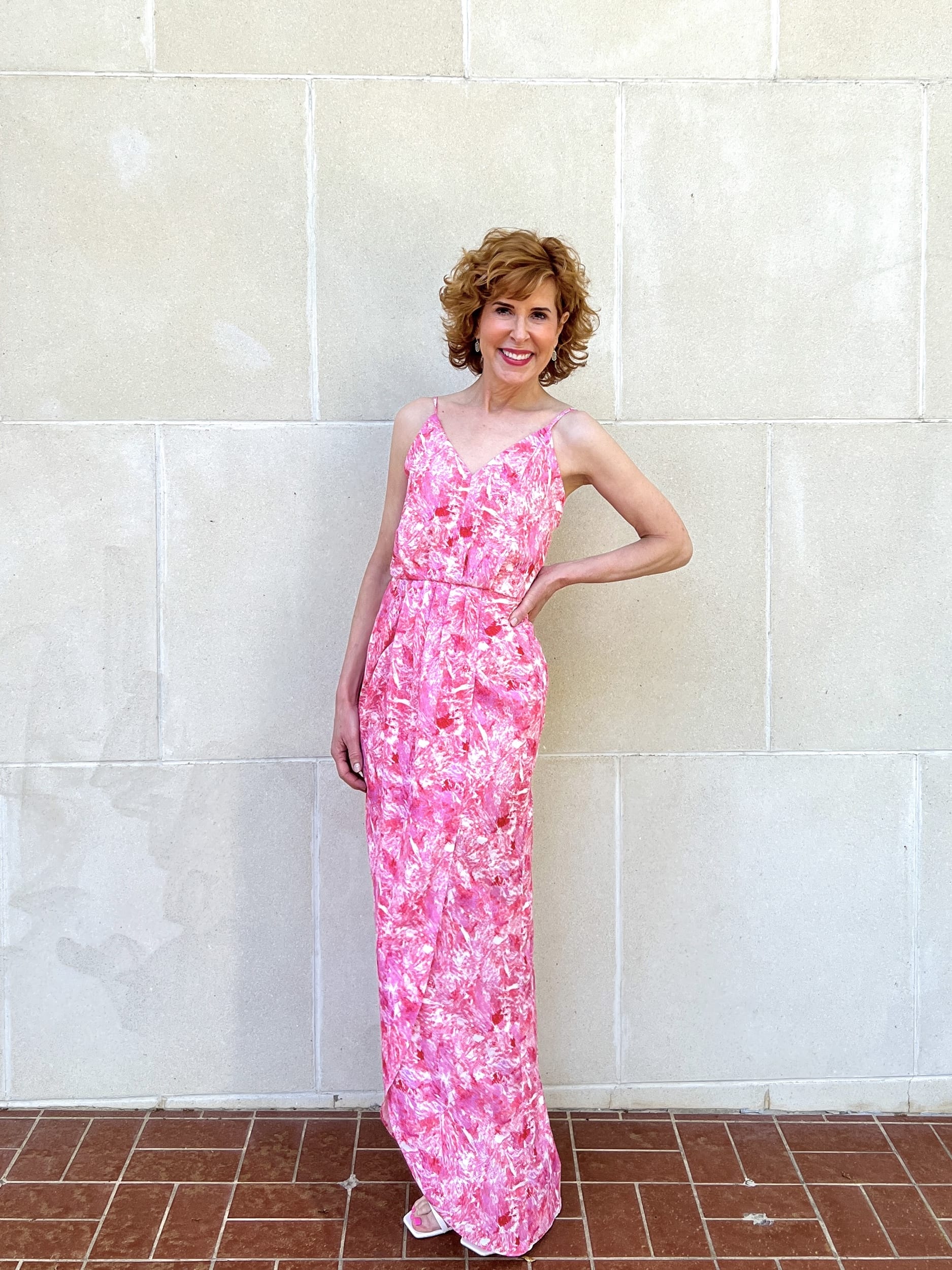 woman over 50 posing in front of a white wallFaux Wrap Camisole maxi Dress from nordstrom made brand chelsea 28