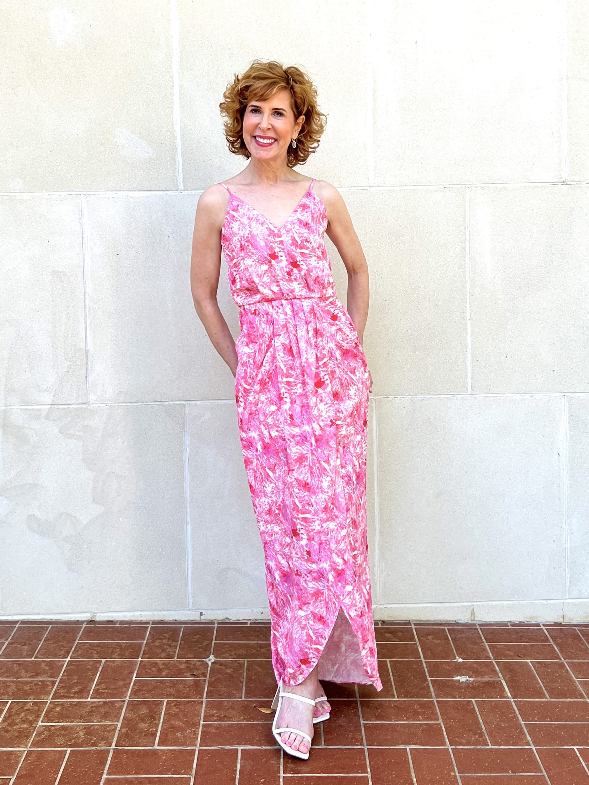woman over 50 posing in front of a white wallFaux Wrap Camisole maxi Dress from nordstrom made brand chelsea 28