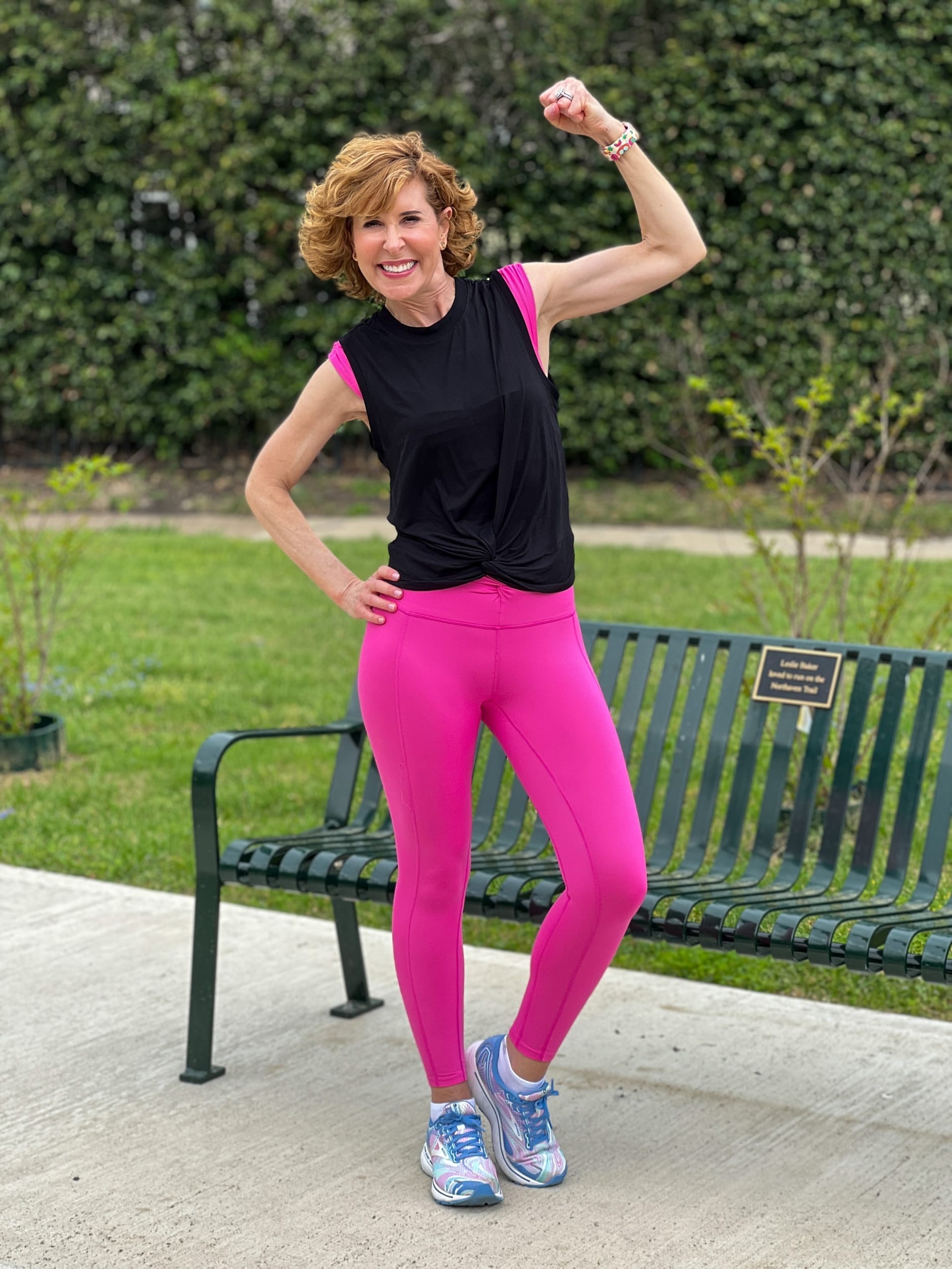 woman over 50 wearing free people Movement Breathe Deeper Leggings and crop top with zella sleeveless twist front tee on top