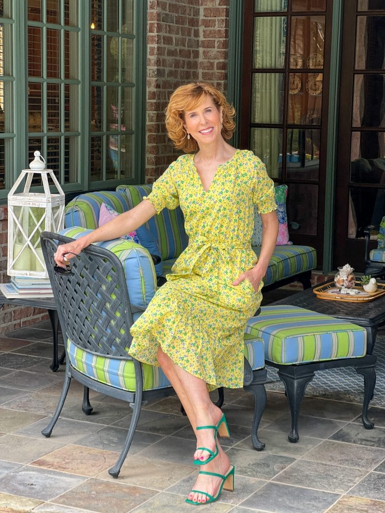 woman sitting on her back porch wearing Floral Smocked Voile Fit & Flare Dress from Talbots sharing tips for empty nesters