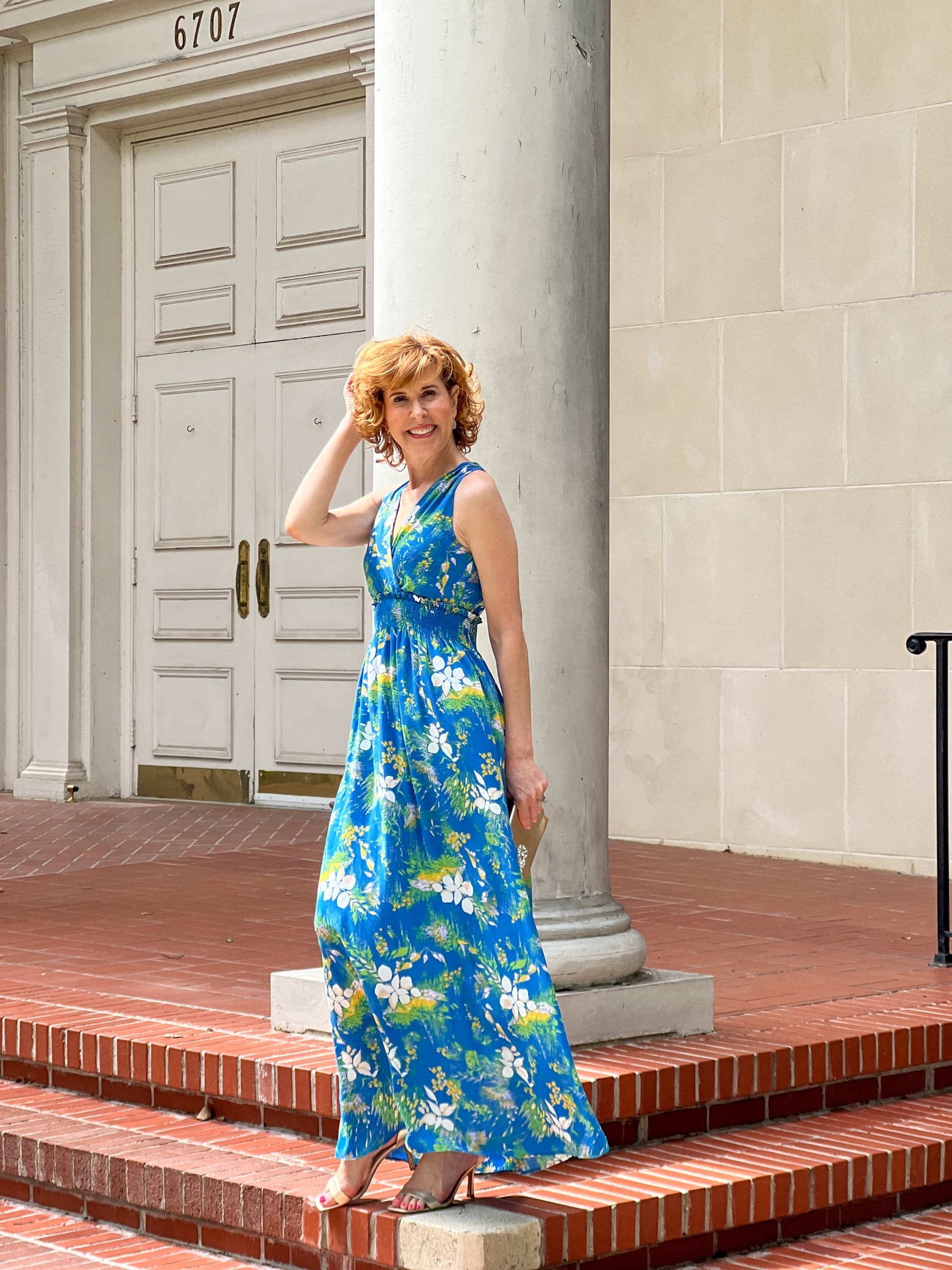woman standing on the porch of a church wearing Halogen® Wrap Front Halter Dress
