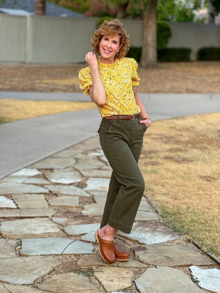 woman wearing spanx Stretch Twill Cropped Wide Leg Pant amazon romwe top and jcrew clogs standing on a stone walkway