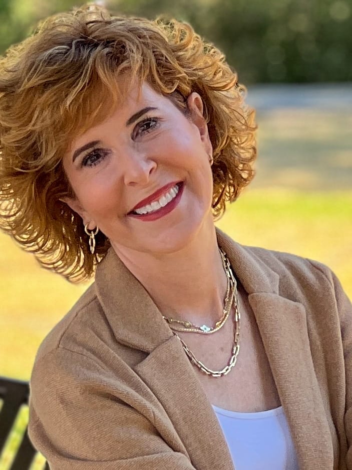 woman wearing multiple gold necklaces stacked