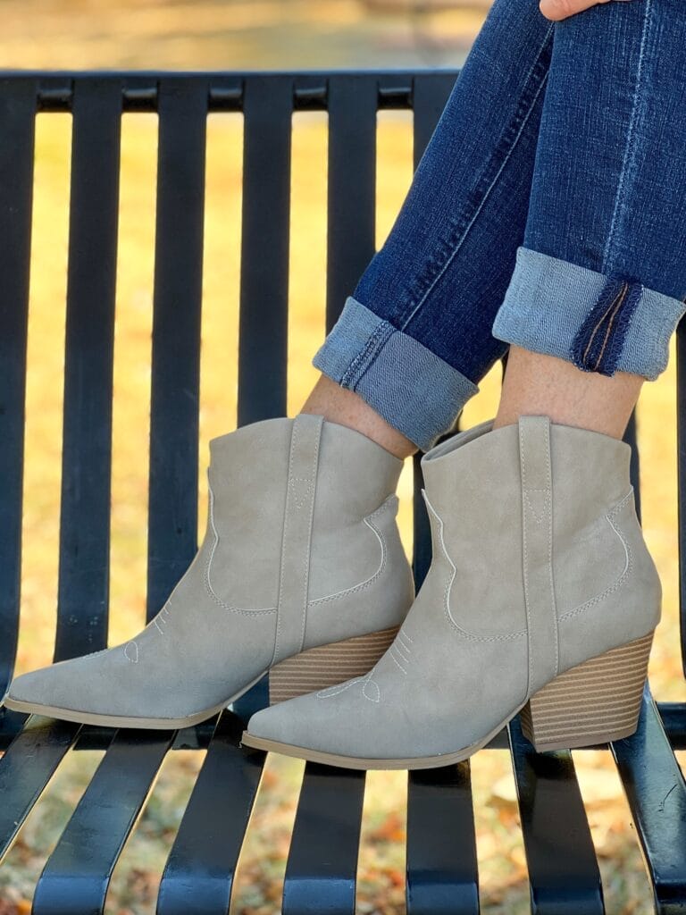 woman wearing avara carissa booties on a park bench