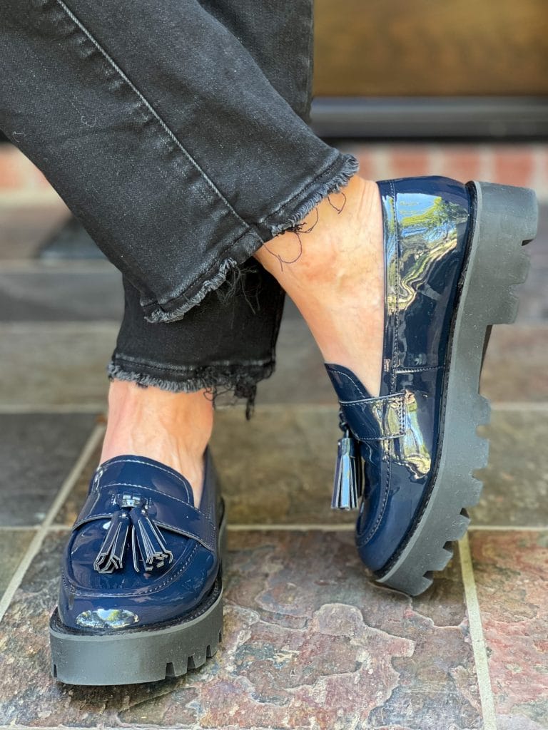 woman wearing SARTO by Franco Sarto Balinna Platform Loafer in midnight blue with black jeans