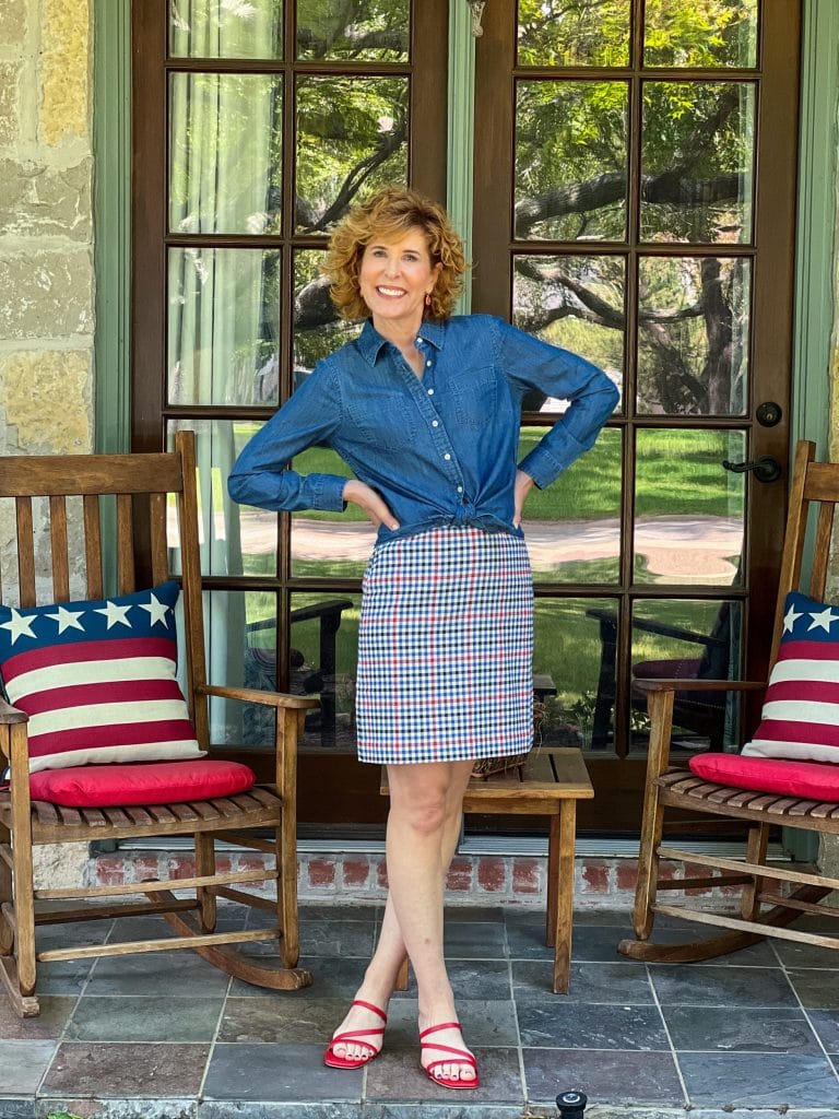 woman standing on porch wearing talbots Denim Button Front Shirt and Gingham Plaid A-Line Skirt