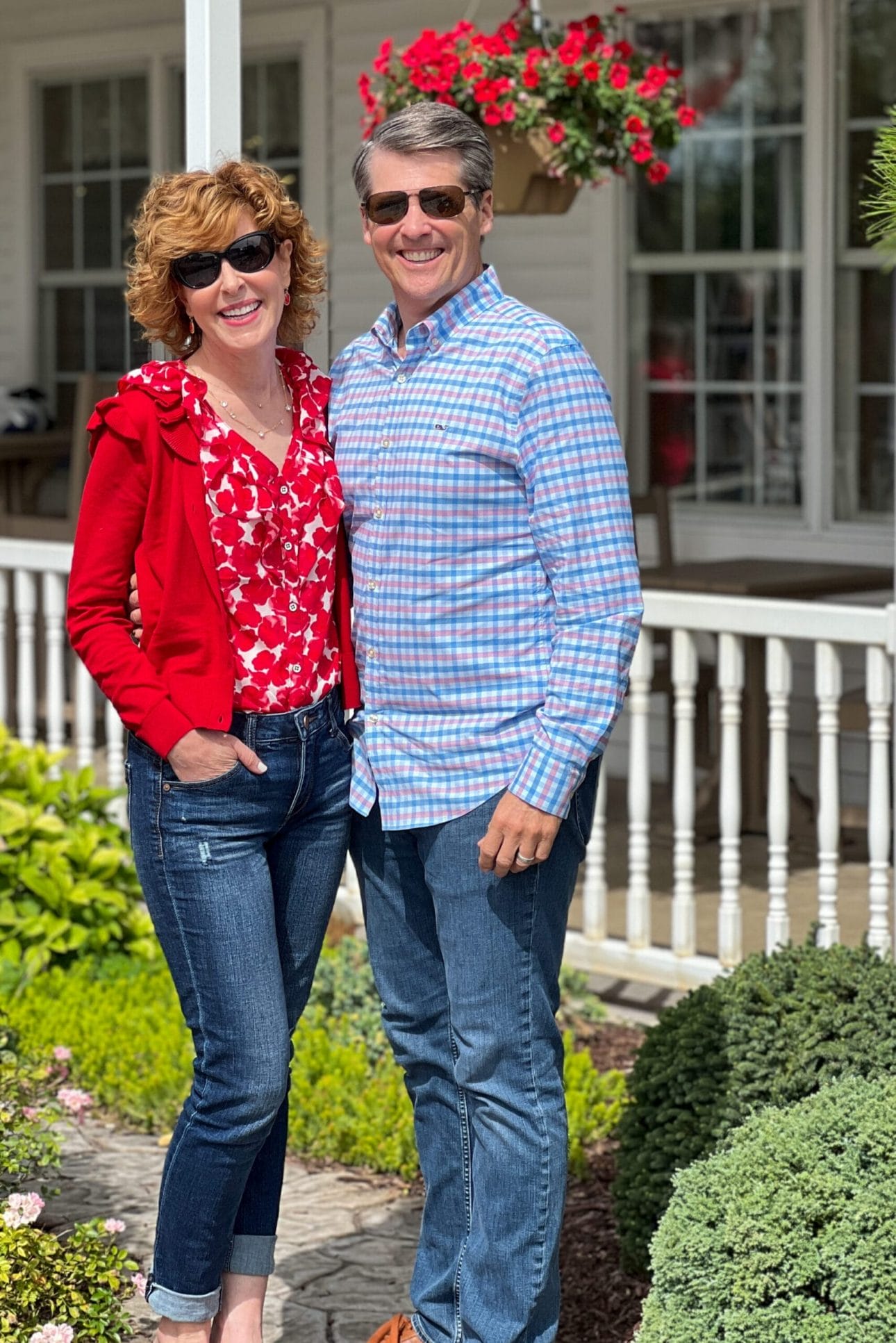 man and woman standing in front of white porch railing outdoors woman wearing cabi fall collection clothing