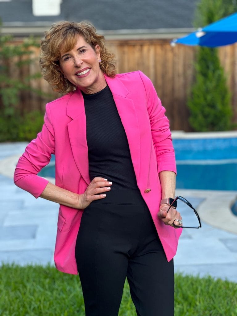 woman barbiecore trend in anthropologie black maeve mock sleeveless turtleneck, spanx perfect pant, black sam edelman pumps, and amazon the drop Blake Long Blazer in hot pink