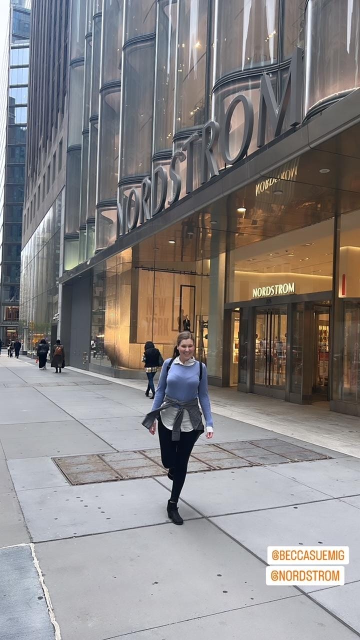 young woman standing in front of Nordstrom on 57th st in manhattan
