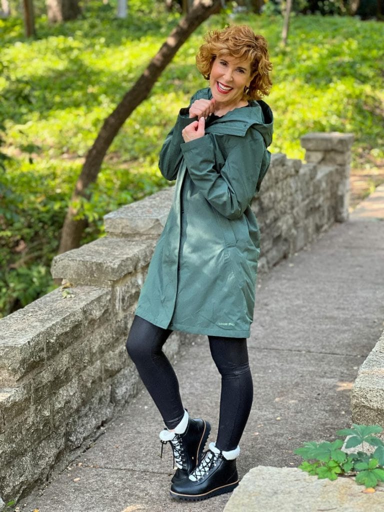 woman wearing green land's end Women's Insulated 3 in 1 Primaloft Parka – outer rain coat part - and black leggings on a bridge in the park