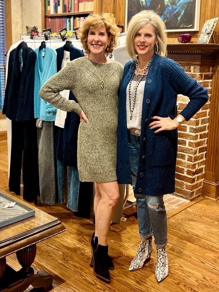two women at a cabi fashion experience in front of a clothing rack