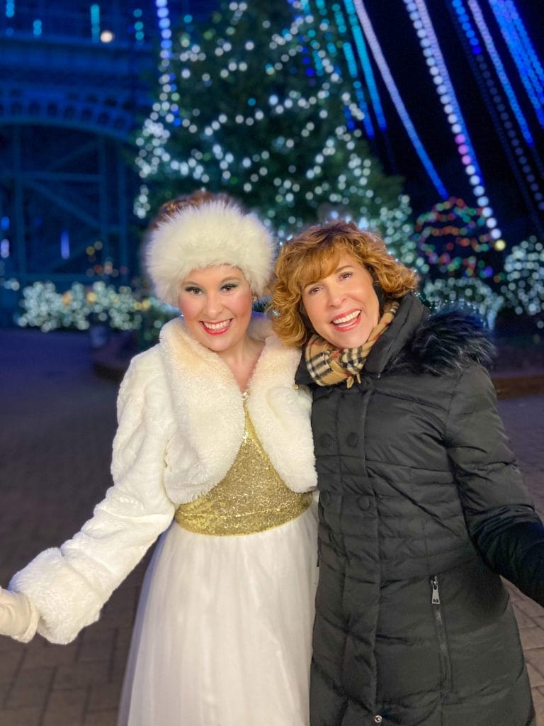 woman in black coat and girl in cream faux fur outfit at winterfest in kings dominion, virginia