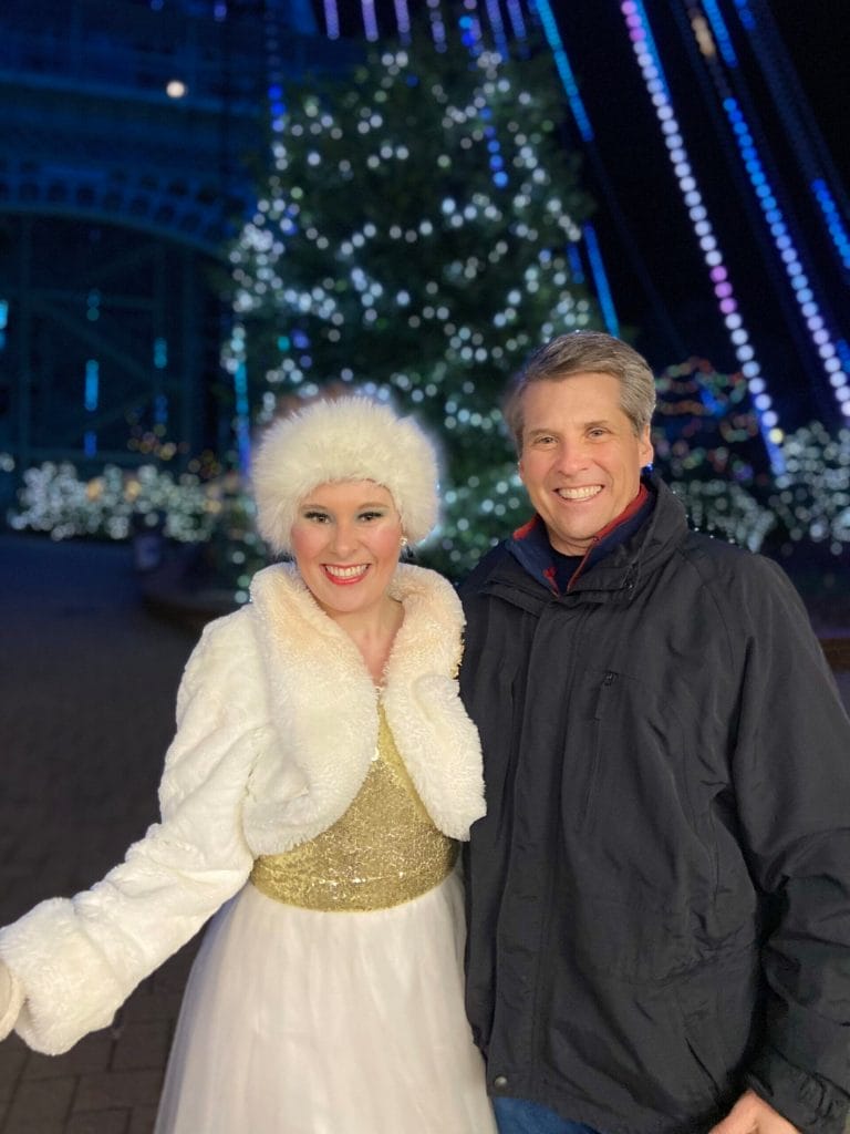man in black coat and girl in cream faux fur outfit at winterfest in kings dominion, virginia