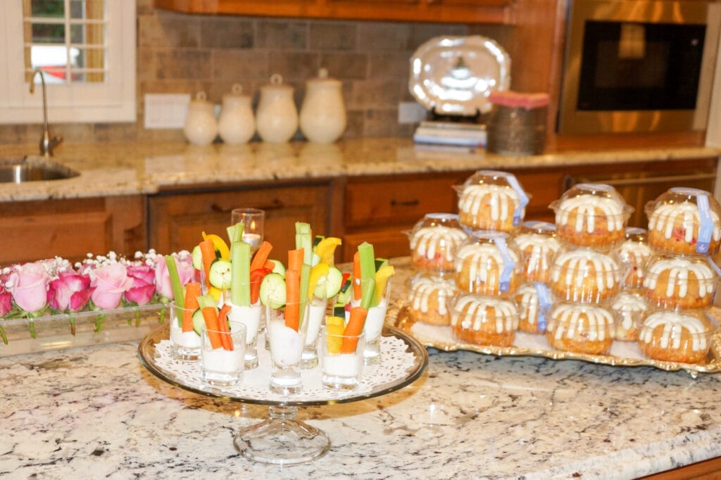veggie shooters and individual bundt cakes on serving platters