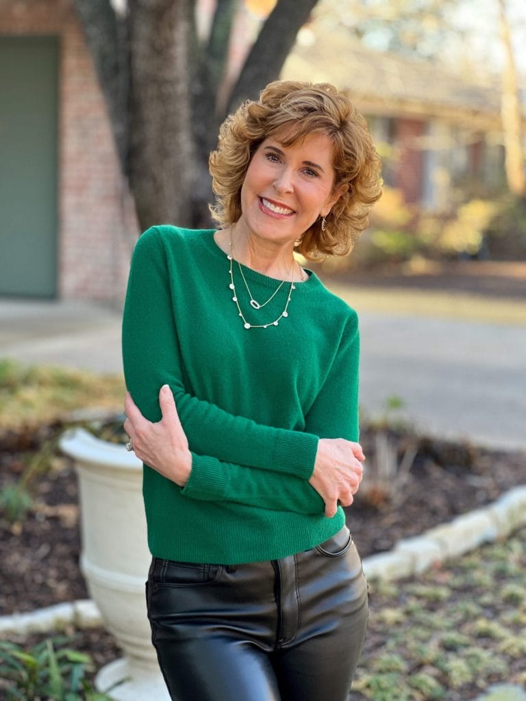 woman over 50 wearing green cashmere sweater