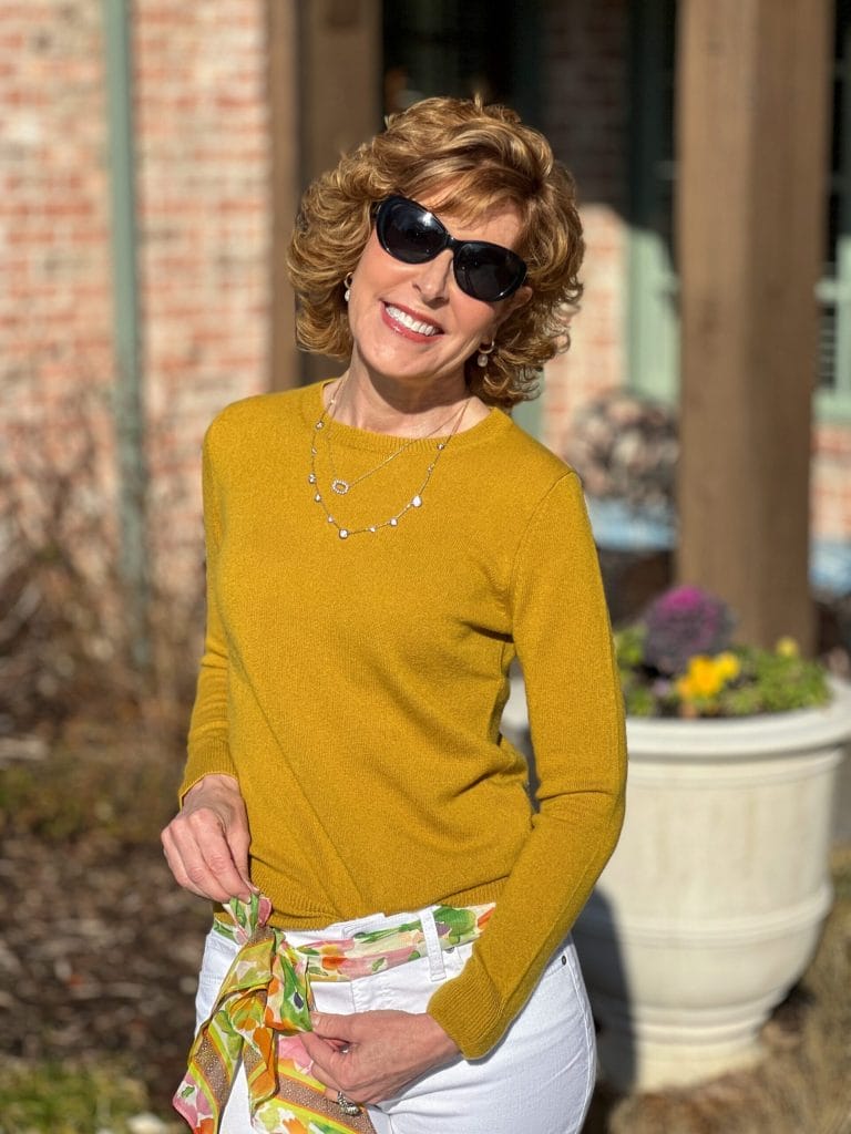 woman wearing sunglasses and a yellow cashmere sweater