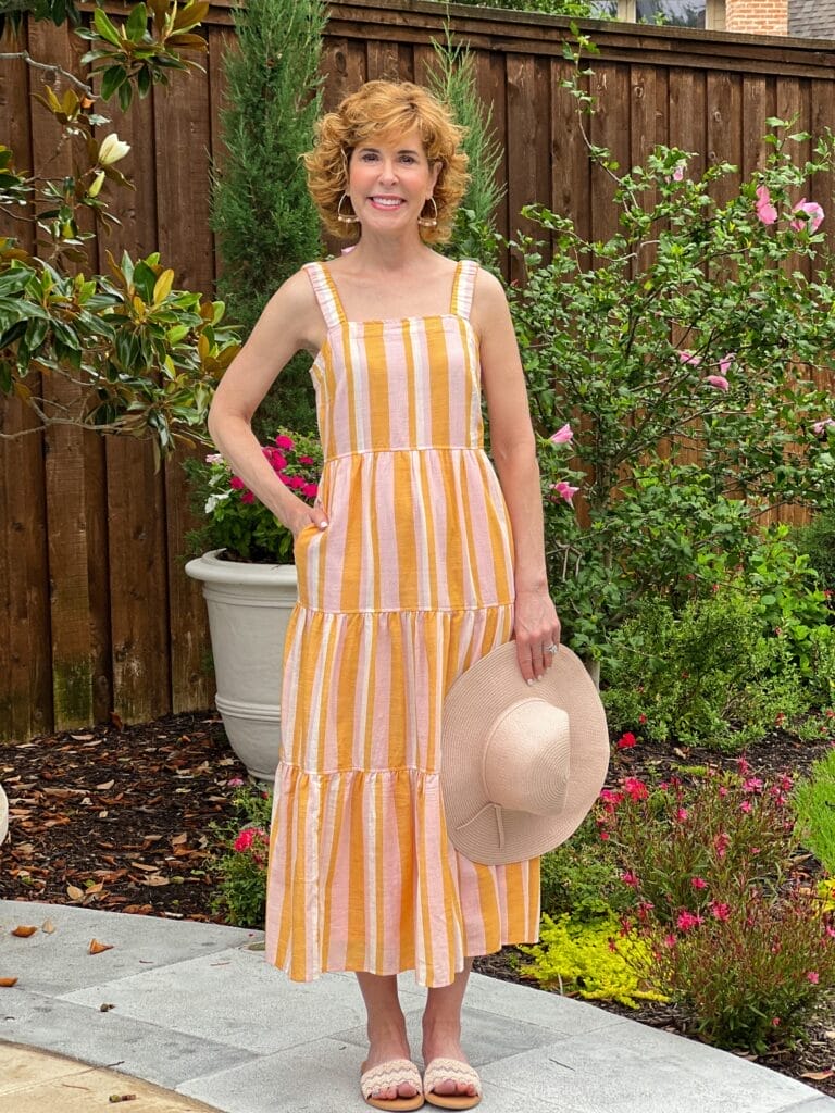 woman wearing Free Assembly Women's Sleeveless Square Neck Maxi standing in a garden holding a hat