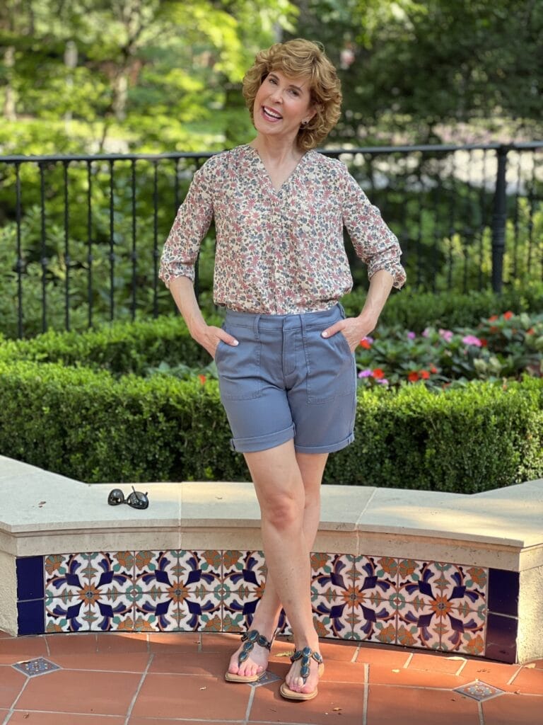 woman posing wearing nydj cargo shorts in blue stone and pintuck blouse with 3/4 sleeves