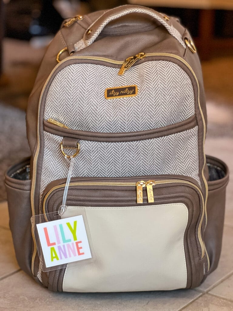 brown backpack diaper bag with colorful personalized tag