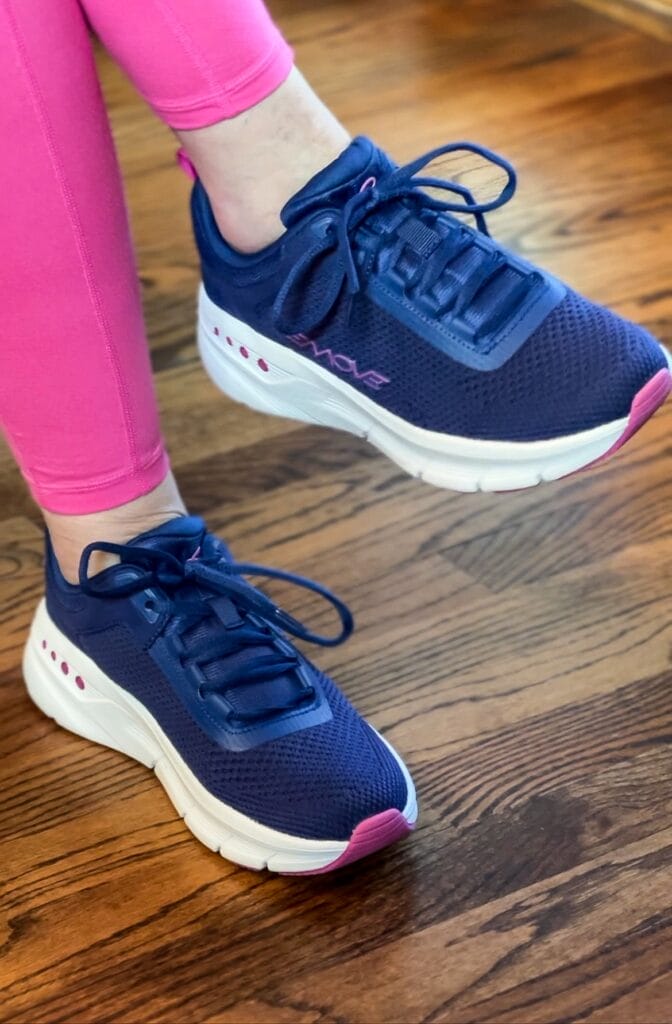woman wearing pink leggings and navy and pink easy spirit emove sneakers