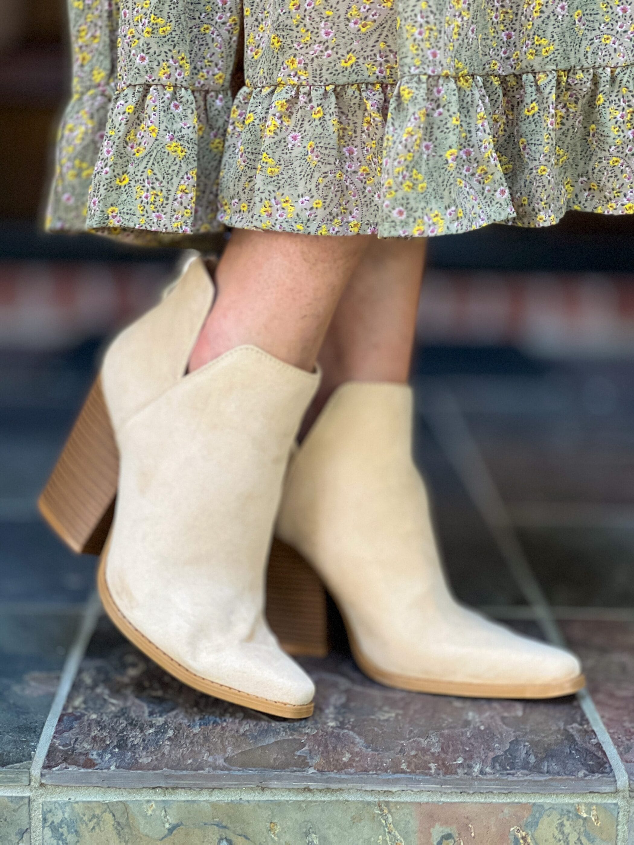 woman's feet wearing faux suede booties